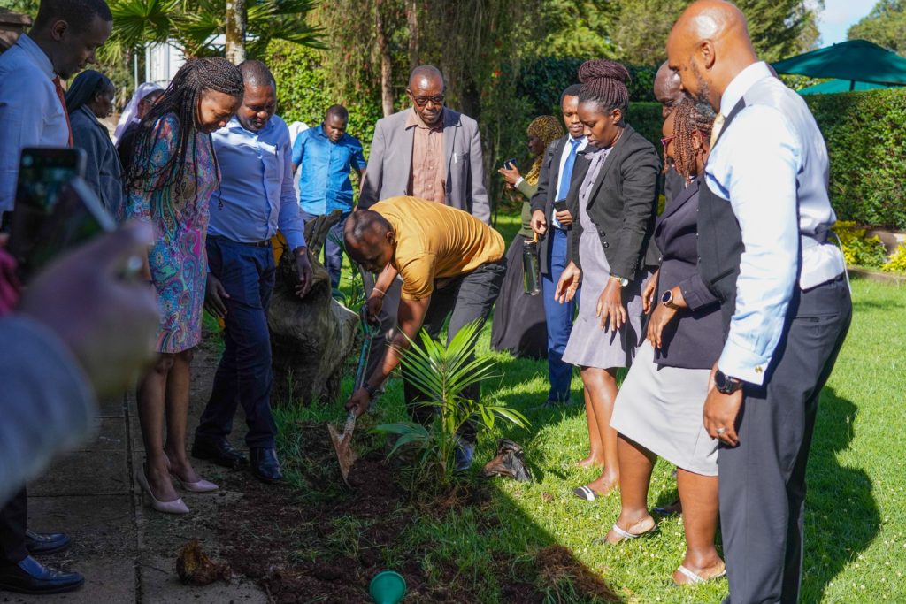 Participants participating in a tree planting exercise in honor of National Tree Growing Day